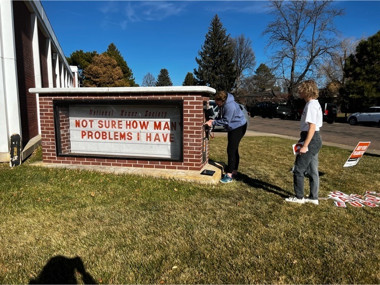 students updating the marquee at the high school