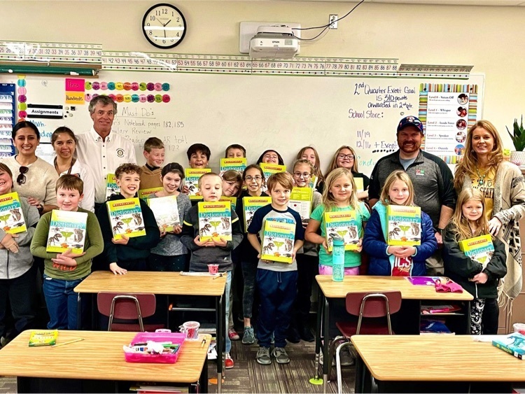 rotary members and 3rd grade students  with dictionaries