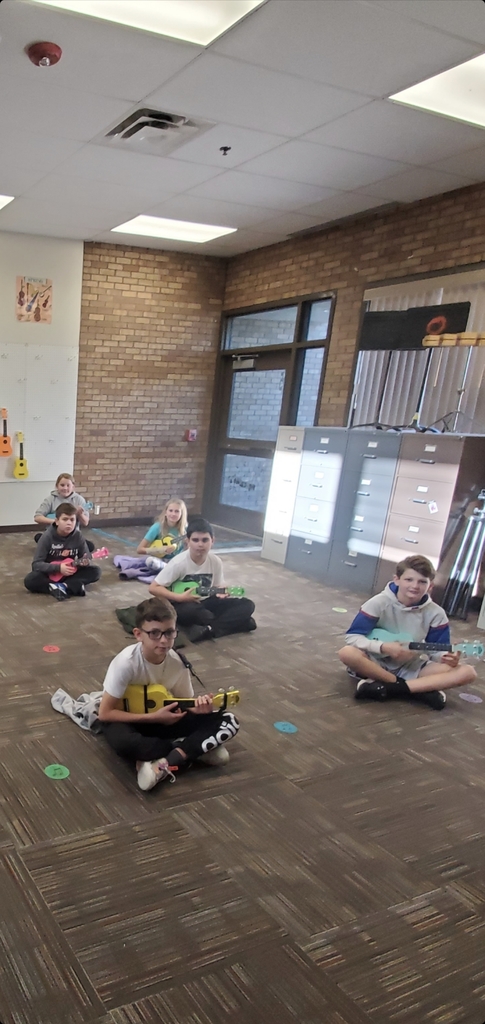 Students sitting with ukulele 
