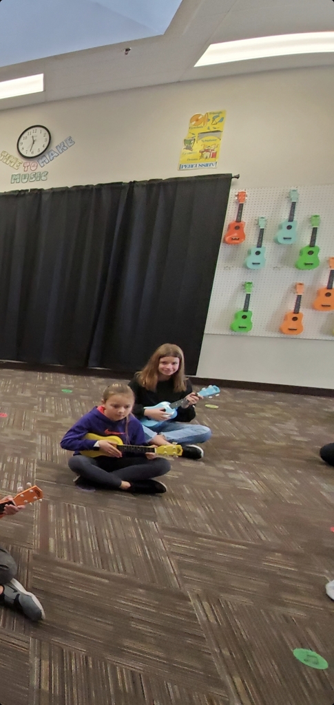 Students sitting with ukulele 