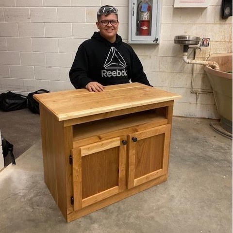 Matthew with his tv stand 